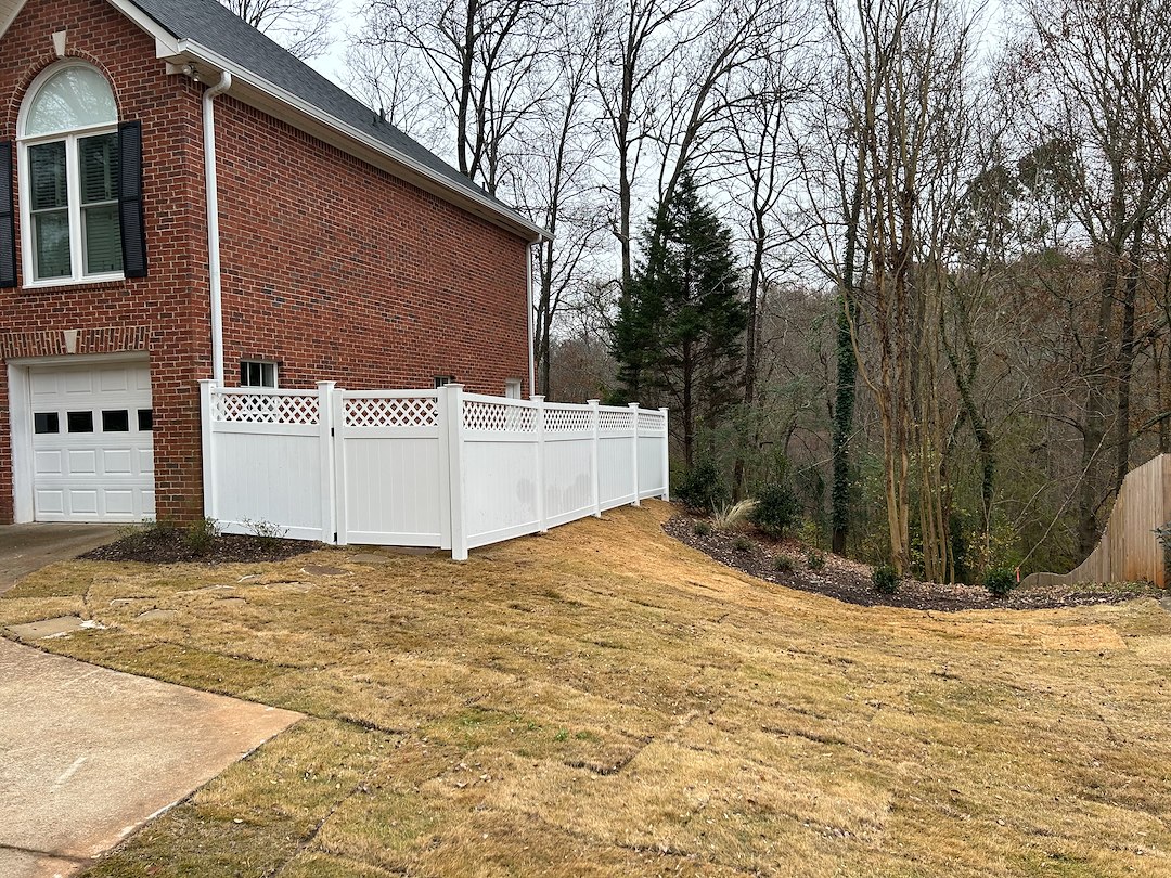 Fresh Turf, Stylish Vinyl Fencing, and Beautiful Plantings for a Perfect Landscape Makeover for this Athens Home.